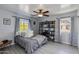 Bedroom showcasing a cozy atmosphere with tile flooring, a ceiling fan, and window views at 6907 S 8Th Dr, Phoenix, AZ 85041