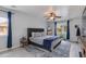 Bedroom featuring a well-lit space with a ceiling fan and two windows draped with blue curtains at 6907 S 8Th Dr, Phoenix, AZ 85041
