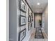 Hallway decorated with picture frames and a blue and white rug on the wood-look tile flooring at 6907 S 8Th Dr, Phoenix, AZ 85041