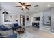 Bright, open-concept living room with modern furnishings, a ceiling fan, and a staircase at 6907 S 8Th Dr, Phoenix, AZ 85041