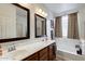 Bright bathroom featuring double sinks, a bathtub, and neutral-toned decor at 6932 W Harwell Rd, Laveen, AZ 85339