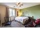 Comfortable bedroom features a ceiling fan, natural light from the window, and a relaxing atmosphere at 6932 W Harwell Rd, Laveen, AZ 85339