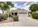 Charming single-story home with a well-manicured front yard and a two-car garage in a suburban setting at 6932 W Harwell Rd, Laveen, AZ 85339