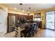 Well-equipped kitchen with stainless steel appliances, a large island, and dark wood cabinets at 6932 W Harwell Rd, Laveen, AZ 85339