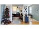 Inviting living room featuring a Christmas tree, and open access to a study room with a work desk at 6932 W Harwell Rd, Laveen, AZ 85339