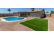 Spacious backyard featuring a sparkling blue pool, a manicured lawn, and desert landscaping at 701 W Mesquite St, Chandler, AZ 85225