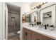 Beautifully renovated bathroom with dual sinks, modern fixtures, and a glass-enclosed shower at 701 W Mesquite St, Chandler, AZ 85225