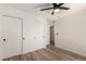 Bedroom with wood-look floors, a ceiling fan and a double closet provide ample space and comfort at 701 W Mesquite St, Chandler, AZ 85225