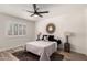 Cozy bedroom featuring a ceiling fan, statement mirror, and stylish lamps on wooden side tables at 701 W Mesquite St, Chandler, AZ 85225