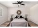 Bright bedroom featuring a ceiling fan, statement mirror, and stylish lamps on wooden side tables at 701 W Mesquite St, Chandler, AZ 85225