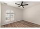 Empty bedroom with vaulted window, ceiling fan, and wood-look flooring provides a bright and airy space at 701 W Mesquite St, Chandler, AZ 85225