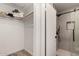 Walk-in closet adjacent to an updated walk-in shower featuring modern tile and black hardware at 701 W Mesquite St, Chandler, AZ 85225