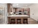 Updated kitchen with stainless steel appliances, modern cabinets, quartz countertops, and seating at the island at 701 W Mesquite St, Chandler, AZ 85225