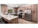 Modern kitchen featuring stainless steel appliances, light wood cabinetry, and marble countertops at 701 W Mesquite St, Chandler, AZ 85225
