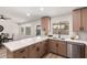 Updated kitchen with stainless steel appliances, modern cabinets, quartz countertops, and a view of the pool at 701 W Mesquite St, Chandler, AZ 85225