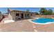Backyard with pool, desert landscaping, and covered patio at 701 W Mesquite St, Chandler, AZ 85225