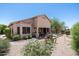 Expansive backyard featuring desert landscaping, a covered patio, and a glimpse of the home's exterior at 7144 E San Cristobal Way, Gold Canyon, AZ 85118