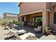 Outdoor patio with a built-in grill, dining table, lounge chairs, and landscaped area for relaxing at 7144 E San Cristobal Way, Gold Canyon, AZ 85118