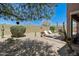 Expansive backyard featuring desert landscaping, patio seating, and a shaded lounge area at 7144 E San Cristobal Way, Gold Canyon, AZ 85118