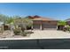 Well-maintained home featuring desert landscaping, a spacious driveway, and a two-car garage at 7144 E San Cristobal Way, Gold Canyon, AZ 85118