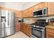 Close-up of a well-equipped kitchen with stainless steel appliances and wood cabinets at 7144 E San Cristobal Way, Gold Canyon, AZ 85118
