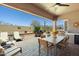 Expansive covered patio with outdoor kitchen, dining, and lounge seating, perfect for entertaining at 7144 E San Cristobal Way, Gold Canyon, AZ 85118