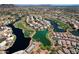 Scenic aerial view of the community featuring a lake, golf course, and well-maintained homes at 7272 W Crystal Rd, Glendale, AZ 85308