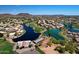Gorgeous aerial view of the community with a lake, golf course, and mountain backdrop at 7272 W Crystal Rd, Glendale, AZ 85308