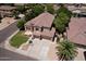 Spacious home showcasing a well-manicured lawn, mature trees, and convenient three-car garage, in a desirable neighborhood at 7272 W Crystal Rd, Glendale, AZ 85308