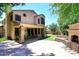 Charming backyard with a stone fireplace, patio, lush artificial grass, and a swing set at 7272 W Crystal Rd, Glendale, AZ 85308