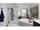 Bright bathroom with a glass shower and soaking tub under a window for a relaxing experience at 7272 W Crystal Rd, Glendale, AZ 85308