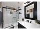 Stylish bathroom featuring a glass shower door, modern vanity, and decorative wall shelves with lovely decor accents at 7272 W Crystal Rd, Glendale, AZ 85308
