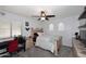 Cozy bedroom with a ceiling fan, a window with blinds, and a charming beige bed frame and matching furniture at 7272 W Crystal Rd, Glendale, AZ 85308