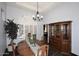 Elegant dining room with a wood table, decorative hutch, and large window at 7272 W Crystal Rd, Glendale, AZ 85308