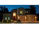 Inviting home exterior with well-manicured landscaping, warm lighting, and a basketball hoop above the garage at 7272 W Crystal Rd, Glendale, AZ 85308