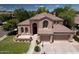 Beautiful home featuring a well-manicured lawn, mature trees, complemented by a spacious three-car garage at 7272 W Crystal Rd, Glendale, AZ 85308