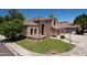 Attractive home with lush green lawn, complemented by mature trees, a charming entrance, and a basketball hoop at 7272 W Crystal Rd, Glendale, AZ 85308