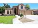 Attractive home featuring a tan facade, three-car garage, and landscaped front yard at 7272 W Crystal Rd, Glendale, AZ 85308