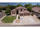 Stunning home with lush front lawn, complemented by mature trees, inviting entrance, and spacious three-car garage at 7272 W Crystal Rd, Glendale, AZ 85308