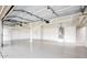 Spacious garage featuring epoxy flooring, bright lighting, shelving, and ample storage space at 7272 W Crystal Rd, Glendale, AZ 85308