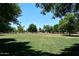 Expansive green space offers a serene view with mature trees, perfect for relaxation and community activities at 7272 W Crystal Rd, Glendale, AZ 85308