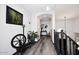 Hallway with hardwood floors, a gallery wall, and a unique spinning wheel decoration creating an intriguing aesthetic at 7272 W Crystal Rd, Glendale, AZ 85308
