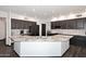 The kitchen features dark wood cabinets, stainless appliances, and an angular granite counter island at 7272 W Crystal Rd, Glendale, AZ 85308
