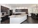 Spacious kitchen features dark cabinets, stainless appliances, and large granite island at 7272 W Crystal Rd, Glendale, AZ 85308