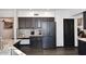Kitchen with dark wood cabinets, stainless steel appliances, desk nook and wood-look flooring at 7272 W Crystal Rd, Glendale, AZ 85308