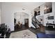 Open-concept living area with a dining space, staircase, and stylish decor at 7272 W Crystal Rd, Glendale, AZ 85308