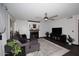 Living room with cozy fireplace, ceiling fan and gray sectional couch at 7272 W Crystal Rd, Glendale, AZ 85308