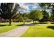 Picturesque park view features a walking path lined with mature trees and lush greenery at 7272 W Crystal Rd, Glendale, AZ 85308