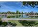 Tranquil pond with walking path, lush landscaping, and neighborhood homes creates a serene community setting at 7272 W Crystal Rd, Glendale, AZ 85308
