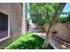 Side yard featuring artificial grass and a paved walkway leading to a gated patio area at 7272 W Crystal Rd, Glendale, AZ 85308